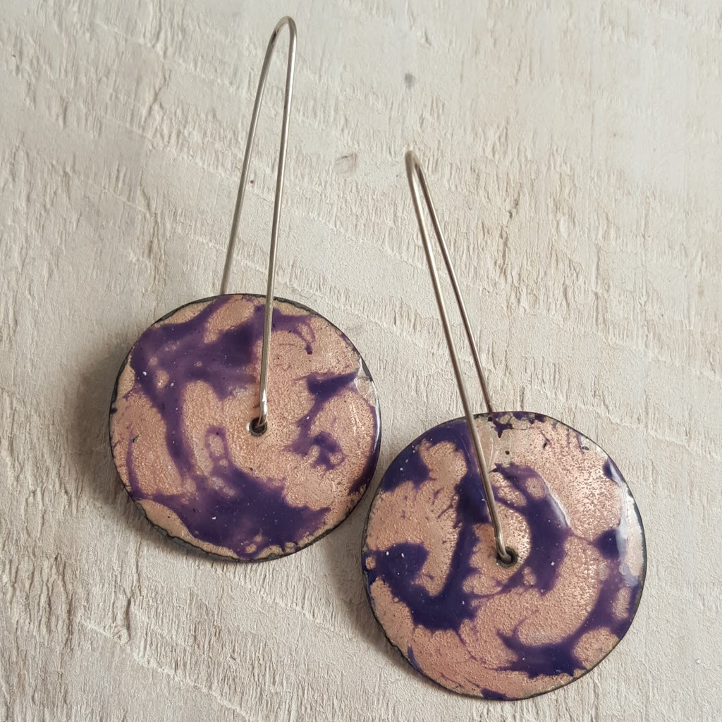 Transparent enameled copper earrings with purple swirl accents.