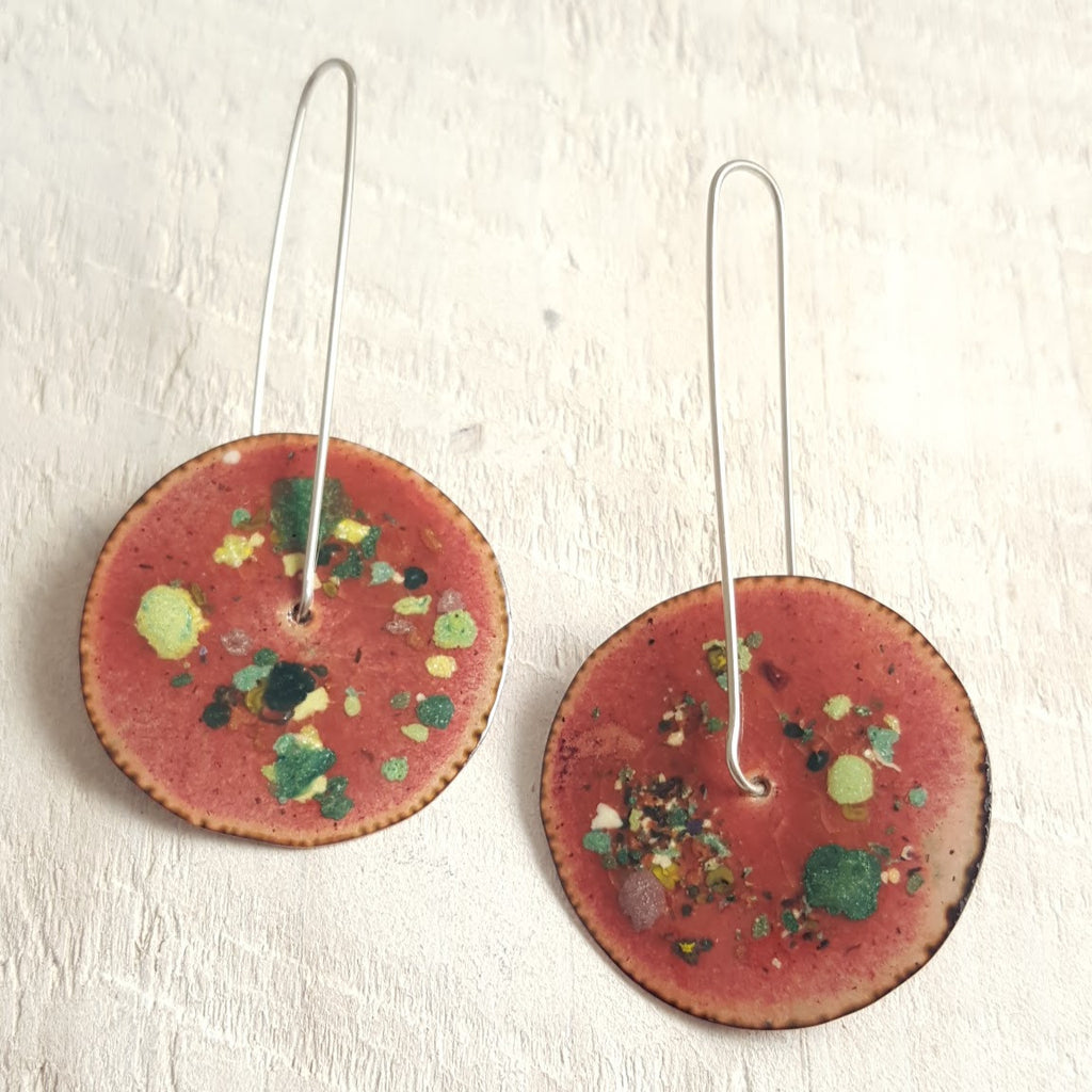 Translucent brown enameled copper earrings with green accents.