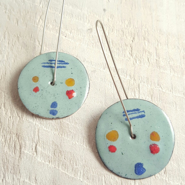 Light blue enameled copper earrings with blue, red, and orange accents.