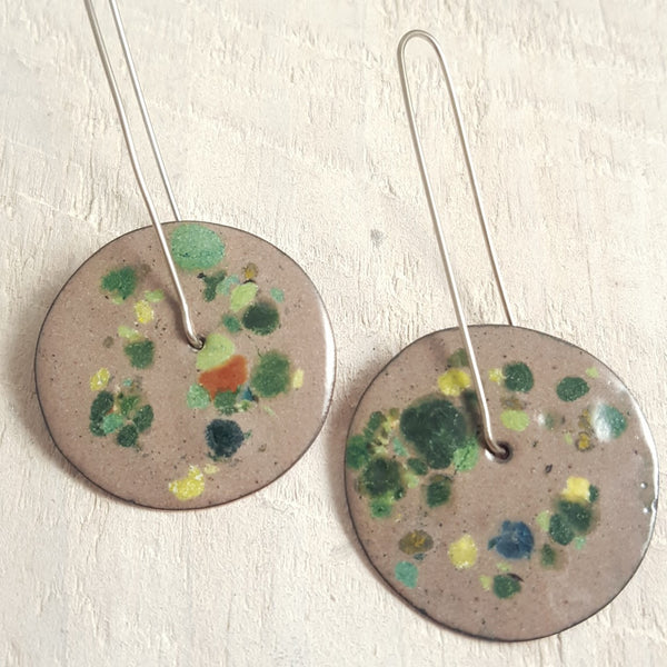 Taupe enameled copper earrings with green accents.