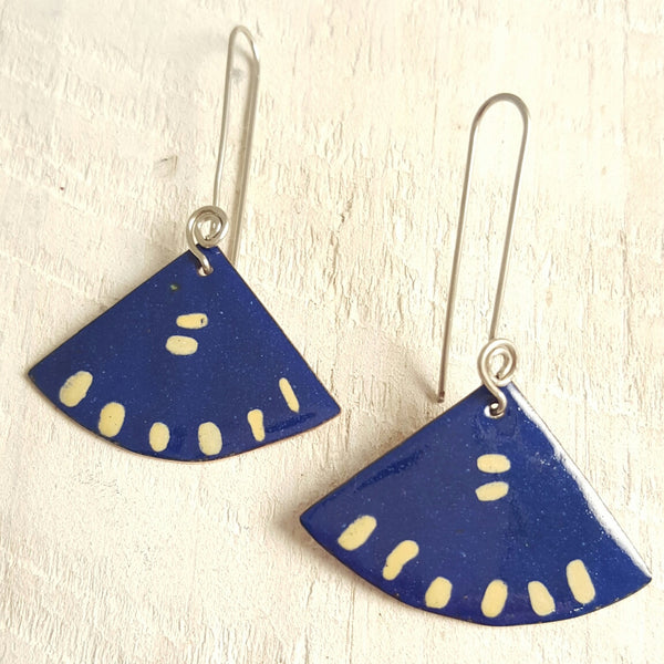 Dark blue enameled copper earring with cream accents.