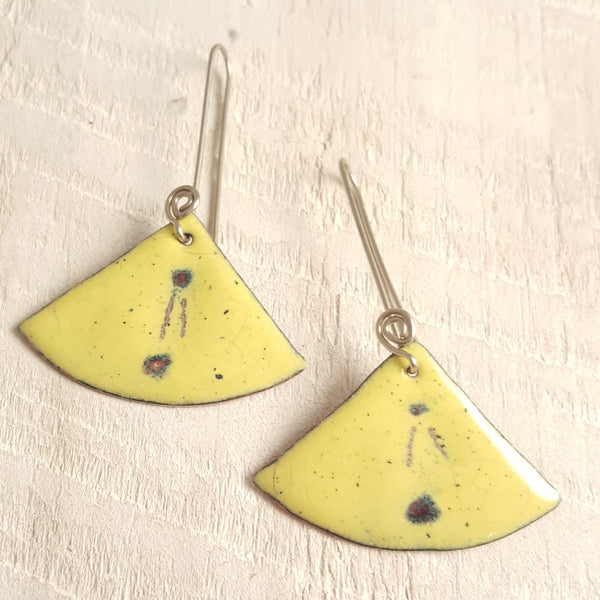 Light yellow enameled copper earring with dot and line accents.