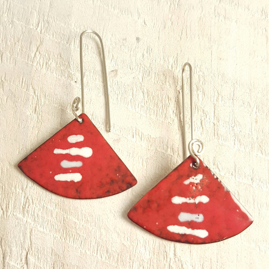 Red enameled copper earring with white stripes.