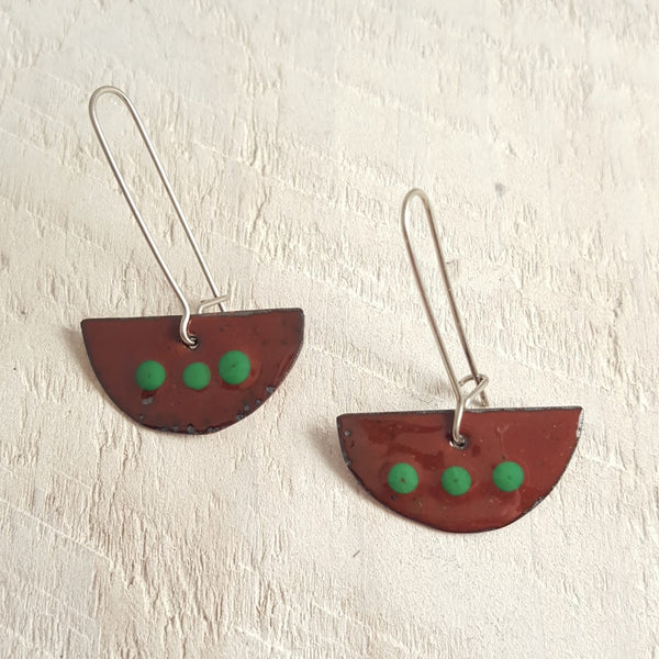 Dark brown enameled copper earrings with green dots.