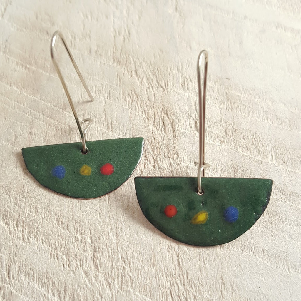 Green enameled copper earrings with red, yellow, and blue dots.