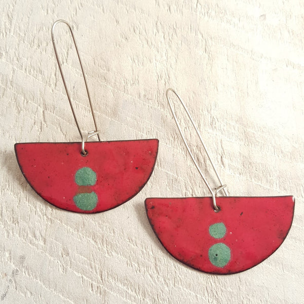 Red enameled copper earring with green accents.