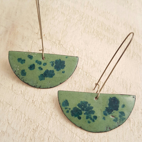 Light green enameled copper earrings with blue accents.