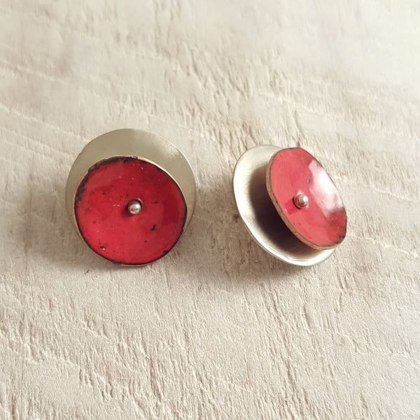 Red enameled copper studs side view.