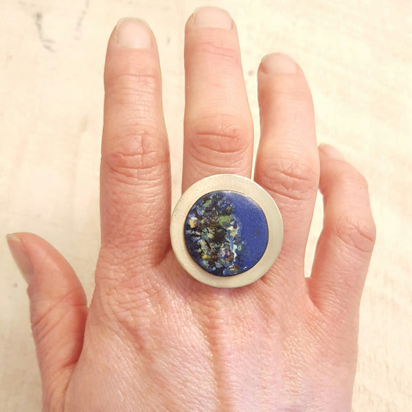 Blue enameled copper ring with speckled accents.