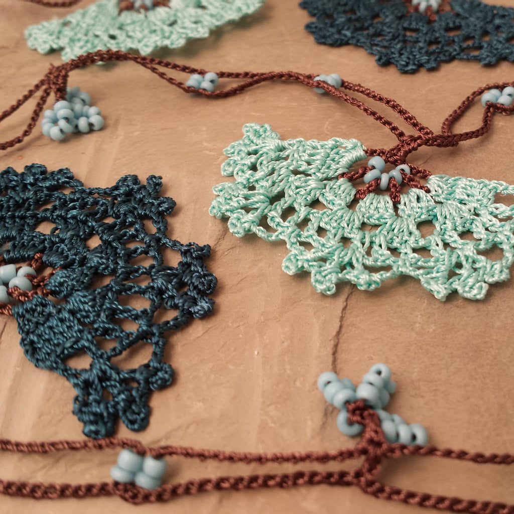 Aqua and teal flowers with brown string.