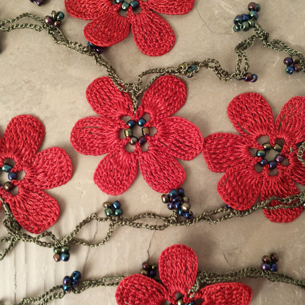 Red flowers with green string.