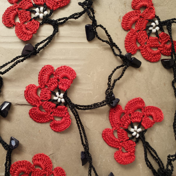 Red flowers with black string.