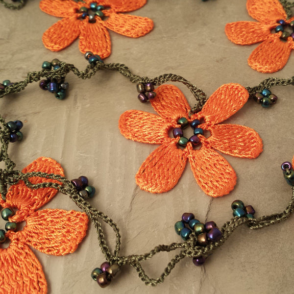 Orange flowers with green string.