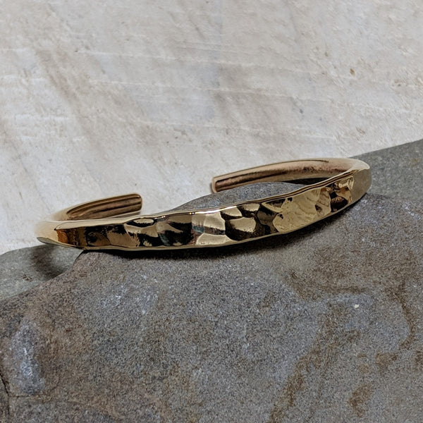 angled view of gold hammered cuff