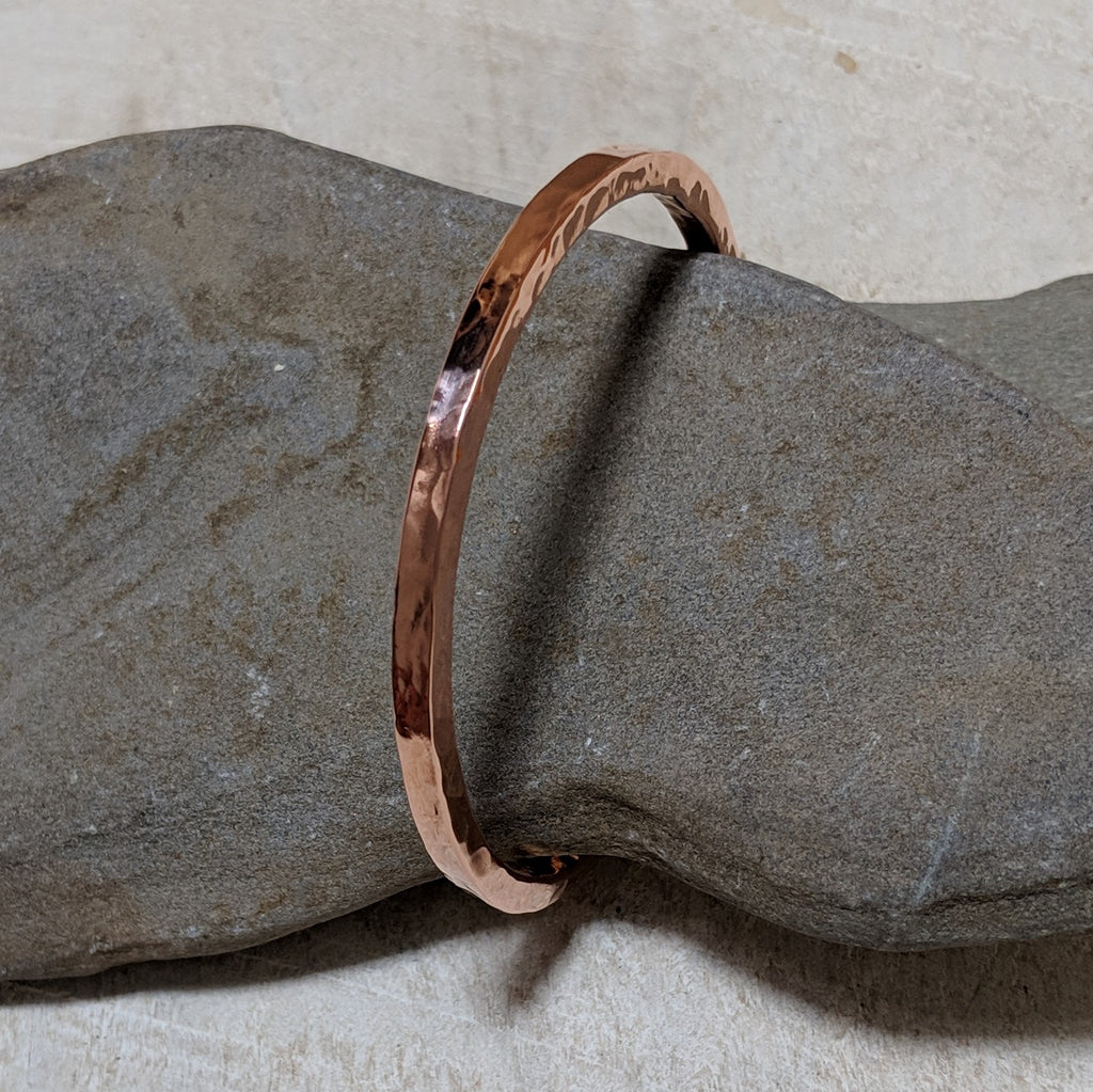 Hammered copper bangle angled view