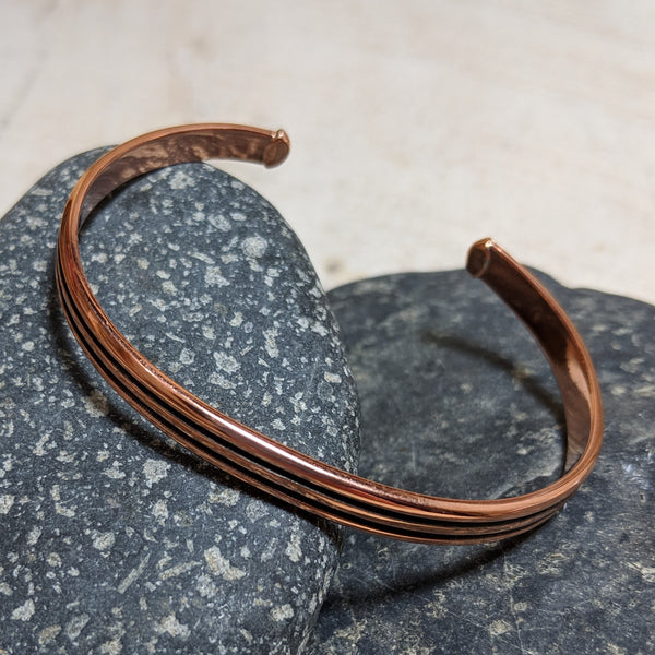 angled view of copper lines cuff
