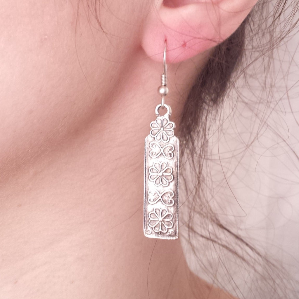 scroll earrings on model
