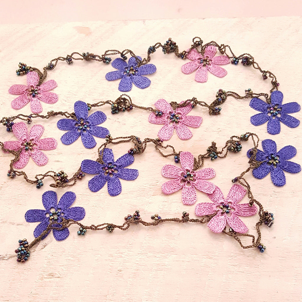 Pink and purple flowers with green string.