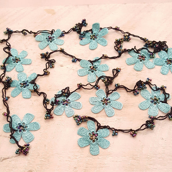 Turquoise flowers with black string.